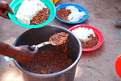 Serving beans and Nsima (corn) at a new orphan feeding center in Mozambique